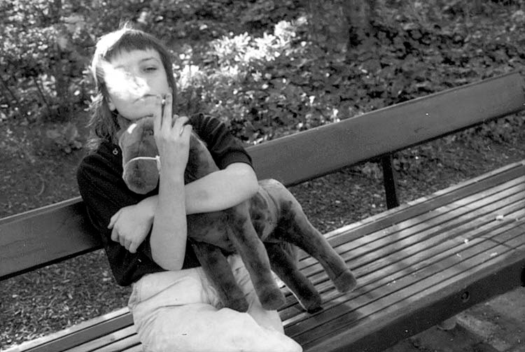 Tiny smoking on a bench with "horsie", Seattle