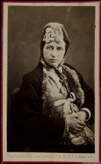Untitled [Woman with decorative scarf on her head, tied at chin]