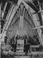 Riveters at work on merchant ship, England