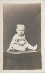 Baby seated on table