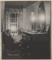 Man reading with candles
