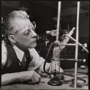 Chemist Julius V. Sommer recording data on micro distillation run.