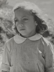 Portrait of young girl in checked, white collared dress