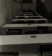 Rows of tables, chairs behind