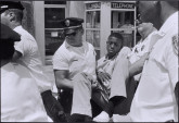 The first sit-in arrests I see and photograph are those of Eddie Brown, a former Albany gang leader, and a visitor from the North. Both have volunteered to be arrested for the photographs. The picture of Eddie Brown, calmly being carried off by the Albany