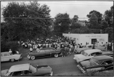 The mass meeting in Danville, Virginia is so crowded that it overflows out into the yard. When word arrives that heavily armed police and an armored vehicle are waiting up the road, the crowd disperses, leaving the SNCC workers to exit last