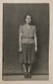 Untitled [Standing young woman with stern expression]