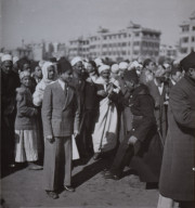 King Farouk's Wedding. Awaiting the Royal coach; police trying to clear the street, Egypt