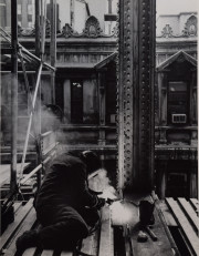 Construction worker welding on scaffolding