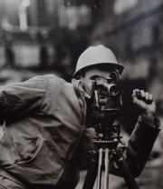Construction worker with land surveying instrument