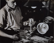 Factory worker using a metal grinder to make a wheel