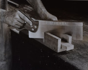 Close-up of hands sawing with Disston U.S.A. saw