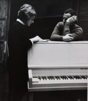 White House secretary Meredith Burch talking to a man over a piano