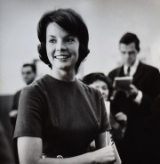Press Secretary to the First Lady Pam Turnure standing with members of the press and White House officials