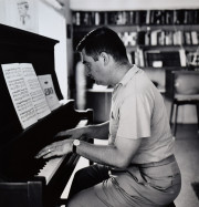 Press Secretary Pierre Salinger playing piano