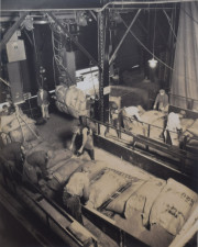 Men moving large bags