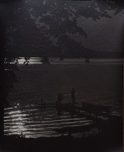 Night view of two fishermen on dock