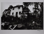 Three boys standing on a rock in the favela, Brazil