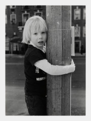 Blond child holding pole, NYC