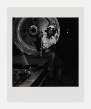 Untitled [Worker Seated on Metal Disk]